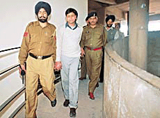 Notorious history sheeter from Uttar Pradesh, Nazeem, being taken by the police to the district courts in Chandigarh on Friday.