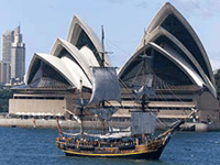 A replica of Captain Cook's 18th century sailing ship HMAS Bounty sails past Sydney's Opera House on Sunday.