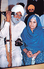 An ailing old man, escorted by his wife, awaits his turn for his case regarding old-age pension to be taken up in the weekly sangat darshan programme in Ludhiana