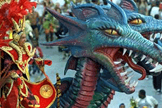 A reveller dances atop a Carnival float with dragon-like figures for the Grande Rio Samba School at the Sambadrome stadium just after sunrise in Rio de Janeiro on Tuesday.