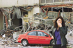 Kristi Heim of Seattle reacts to a crushed car and a collapsed wall at the Starbucks Corporate Headquarters building in the SODO district of downtown Seattle after an earthquake rocked the region, on Thursday. 
