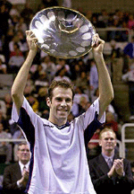 Greg Rusedski holds up his trophy after upsetting Andre Agassi, 6-3, 6-4, in the finals of the Sybase Open on Sunday in San Jose, California.