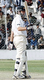 Australian cricket captain Steve Waugh raises his bat on completing a century during the first day�s play of the three-day tour match between the Board President XI and the Australian team in New Delhi on Tuesday.