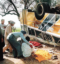 Relatives of killed passengers grieve near the overturned Punjab Roadways bus on the Kharar-Kurali highway on Friday.
