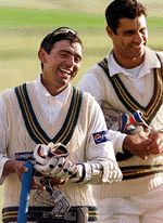 Saqlain Mushtaq (L) is all smiles after batting all day to be 98 not out at stumps with compatriot Waqar Younis 