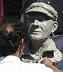 A sculptor puts the final touches onto a bust of the late Australian cricket great Sir Donald Bradman at the cricket stadium in Pune during the second one-day international between India and Australia on Wednesday.