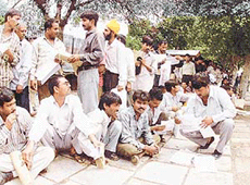 These auto-rickshaw and city bus operators wait for their turn in front of the Supreme Court to file affidavits promising to purchase CNG buses and three-wheelers in New Delhi on Friday.