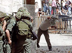 Israel border police take cover behind a wall as Palestinian protesters throw rocks during clashes in the Old City of Jerusalem on Friday.