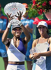 Venus William (left) holds up her championship trophy after defeating Jennifer Capriati (right) on Saturday in the Ericsson Open in Key Biscayne.