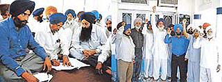 Sarpanches are finalising a memorandum to be submittted against the eviction order of the Army authorities, and (right) villagers hold a protest at Ayali Kalan village  in Ludhiana on Wednesday. 