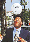 Pele, recently voted "soccer player of the century" and Brazil's former secretary of sport, plays with a ball during a photocall to promote "Soccer, Television's number one sport" during the 38th MIP TV (International Television Programming market), in Cannes, southern France on Wednesday. 