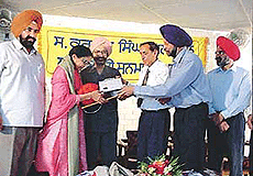 Dr Dalip Kaur Tiwana receives an award at a function held at Punjabi Bhawan in Ludhiana on Sunday.