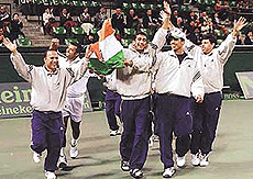 Indian team members carry the national flag during the victory run following their victory over Japan in Tokyo on Sunday.