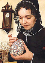 Heidemarie Hoeft, wearing a traditional Slavic Sorbs costume, makes the final touches to a hand painted egg of a Nandu bird, a large flightless bird from South America at her home in the village of Kleinwelka east of Dresden on Tuesday. The Slavic Sorbs number around 150,000 people and are mainly resident in the eastern German states of Brandenburg and Saxony. Germans are preparing for Easter on April 15 in which according to tradition people knock and eat painted eggs. 