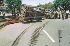 A tractor trailer carrying iron bars overturns near the Tribune Chowk about 11.30 am on Friday. 