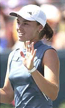 Martina Hingis waves to the crowd after winning the first set of her quarterfinals match against Amelie Mauresmo. Hingis defeated Mauresmo 7-5, 6-2.