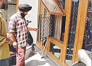 Some residents of the Vardhman factory complex, Focal Point Urban Estate, Ludhiana, show windows that robbers had broken to enter a house, on Saturday.