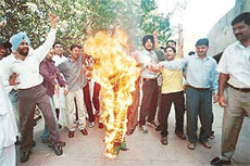 Students of Panjab University burn the Bangladesh flag to protest against the killing of 16 BSF jawans in Meghalaya at the Students Centre in Chandigarh on Sunday.