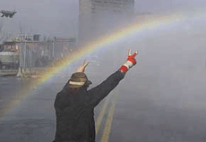 A protester is framed by a rainbow created by jets from a water cannon during riots outside the Summit of the Americas in Quebec city on Saturday. The police used plenty of tear gas and rubber bullets to quell rioters outside the summit.
