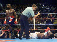 World heavyweight boxing champion Lennox Lewis (R) is counted out after being knocked out by little-known challenger Hasim Rahman of the USA during their world title bout in Brakpan on Sunday.