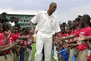West Indies fast bowler Courtney Walsh is greeted by Jamaican school children as he was honoured by the West Indies Cricket Board at the Sabina Park in Kingston, Jamaica, on Saturday. 