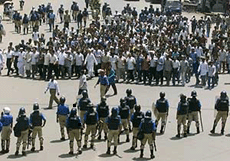 Bangladeshi police stand on alert as opposition activists march in strike-hit Dhaka on Monday. 