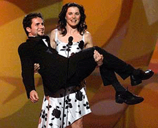 New Zealand actress Lucy Lawless picks up fellow presenter, actor Hal Sparks, as they present an award on Sunday at the 15th annual American Comedy Awards in Los Angeles.