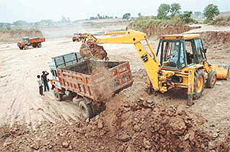 Earth being removed illegally from Dharamgarh village to lay the raised foundation of the Chandigarh-Ludhiana rail track near SAS Nagar on Tuesday.
