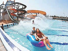 Girls plunge into the water after coming down a 35-foot-high slide in a new section at Fun City, Panchkula, on Friday.