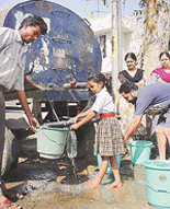With the region in the grip of a heat wave, a schoolgirl fills her water bottle from a tanker in Ludhiana on Saturday.