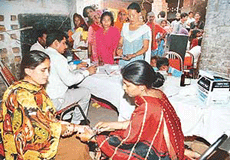 A health worker conducts blood tests in an AIDS awareness camp at Government Primary School, Colony No 5, in Chandigarh, on Sunday.