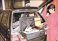 Ms Rewa examines her beauty kit in her vehicle before starting her day. 