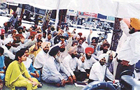 Agri-technocrats sit in dharna in front of the office of the Chief Agriculture Officer, in Ludhiana on Monday.