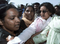 A supporter of former prime minister Benazir Bhutto is arrested by policewomen