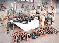 Police officials inspect unfinished .12 bore guns and airguns at an unlicensed arms manufacturing unit in Industrial Area, Phase 1, SAS Nagar, on Wednesday.