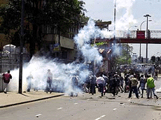 Muslim mobs flee as police fire tear gas outside a mosque in Colombo on Friday.