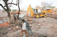 Anti-encroachment staff demolish unauthorised jhuggis in Kabari Market Colony, Industrial Area, Phase I, Chandigarh, on Saturday.