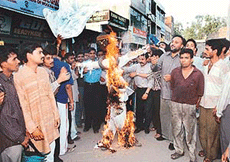 Members of the bharatiya Janata Yuva Morcha burn the effigy of Mr Ajit Jogi, Chief Minister of Chhatisgarh, in protest against the lathi charge on morcha activists, in Mani Majra on Sunday.