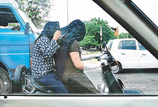 Sensibly protected, a lady drives through the infernal heat on a Chandigarh road on Wednesday.