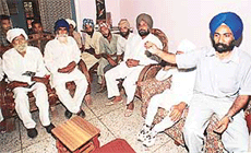 Villagers of Mauli Baidwan hold a meeting to discuss their future course of action on Wednesday. The land of the village is being acquired for expansion of SAS Nagar.