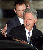 Former US President Bill Clinton departs from a hotel to meet Chinese President Jiang Zemin in Hong Kong on Wednesday.