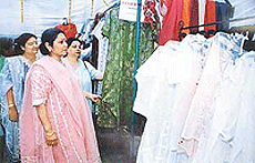 Visitors look at the suits displayed at an exhibition held by the Lakshmi Ladies Club in Ludhiana on Wednesday.