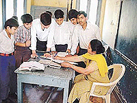 The hearing impaired children learning lessons from a teacher at the Red Cross Deaf and Dumb School for Children.