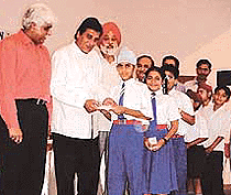 Meritorious students receiving scholarships from MP Vinod Khanna at a function in Ludhiana on Friday.