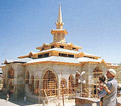 Devotees continue to throng the shrine of Sheikh Nooruddin Wali at Charar-e-Sharief, 30 km east of Srinagar, which is coming up on the new architectural pattern after it was damaged in an encounter on May. 11,1995.