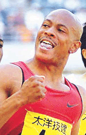 American world record holder Maurice Greene raises his fist as he crosses the finish line to win the men's 100 m race at the IAAF Japan Grand Prix in Osaka on Saturday. 