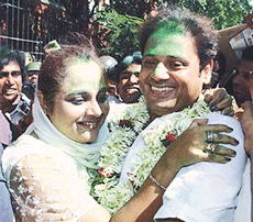Tapas Paul, a candidate of the Trinamool Congress and Bengali film actor, hugs his wife following his electoral victory in Kolkata on Sunday.