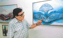 Artist Baldev Gambhir explains his painting titled, �Emergence of life�, at IndusInd Gallery in Sector 8, Chandigarh, on Saturday.