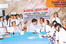 Students of Guru Harkrishan Public School, Sector 40-C, Chandigarh, undergo dental check-up by Dr Sandeep Arora on Saturday. 