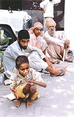 Avtar Singh, a visually and physically challenged boy, cries for water and relief from heat, outside the office of the Civil Surgeon, Ludhiana, on Monday.
